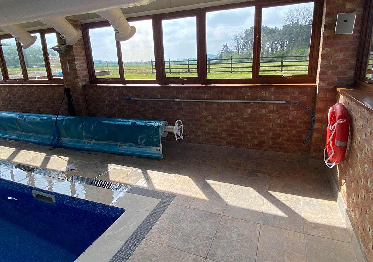 Firtree indoor swimming pool view from the pool over the fields and countryside